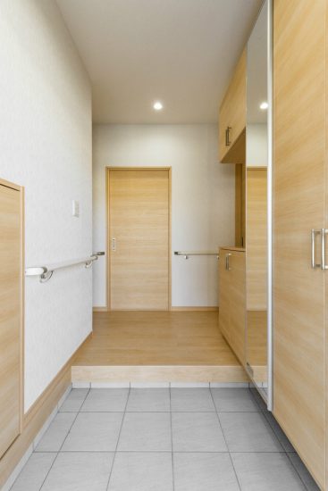 名古屋市中川区のおしゃれなデザインの注文住宅の収納と手すりの付いた玄関ホール