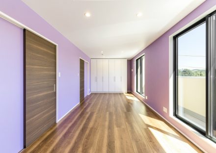 愛知県日進市の注文住宅のパープルの壁　収納とバルコニーの付いた2階洋室